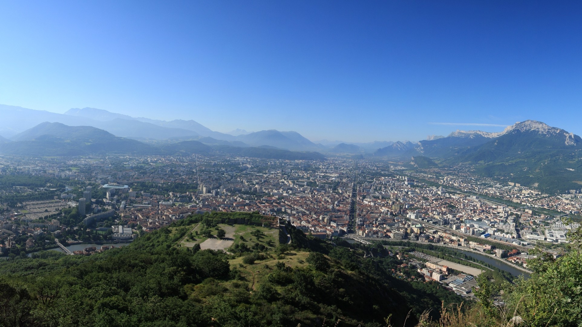 Vue panoramique de Grenoble entourée de ses trois massifs : Belledonne, Chartreuse et Vercors